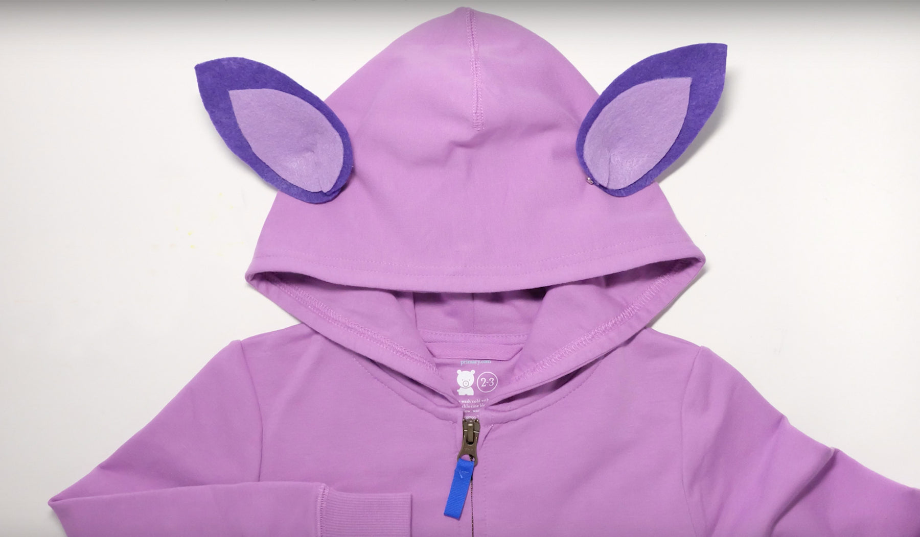 Purple hoodie sweatshirt with small animal ears glued onto the hood.