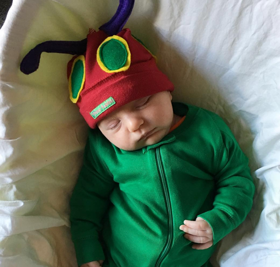 Caterpillar: A baby wearing a green outfit with a "hungry caterpillar" inspired hat using a red beanie