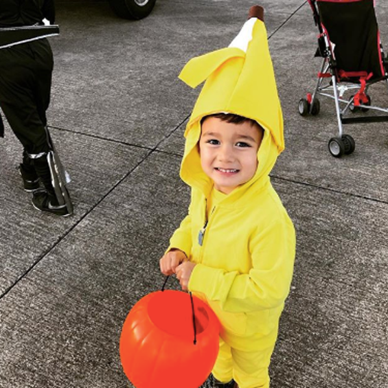 Banana: One child wearing a yellow hoodie and sweatpants with a DIY banana hat on the hood of the jacket.