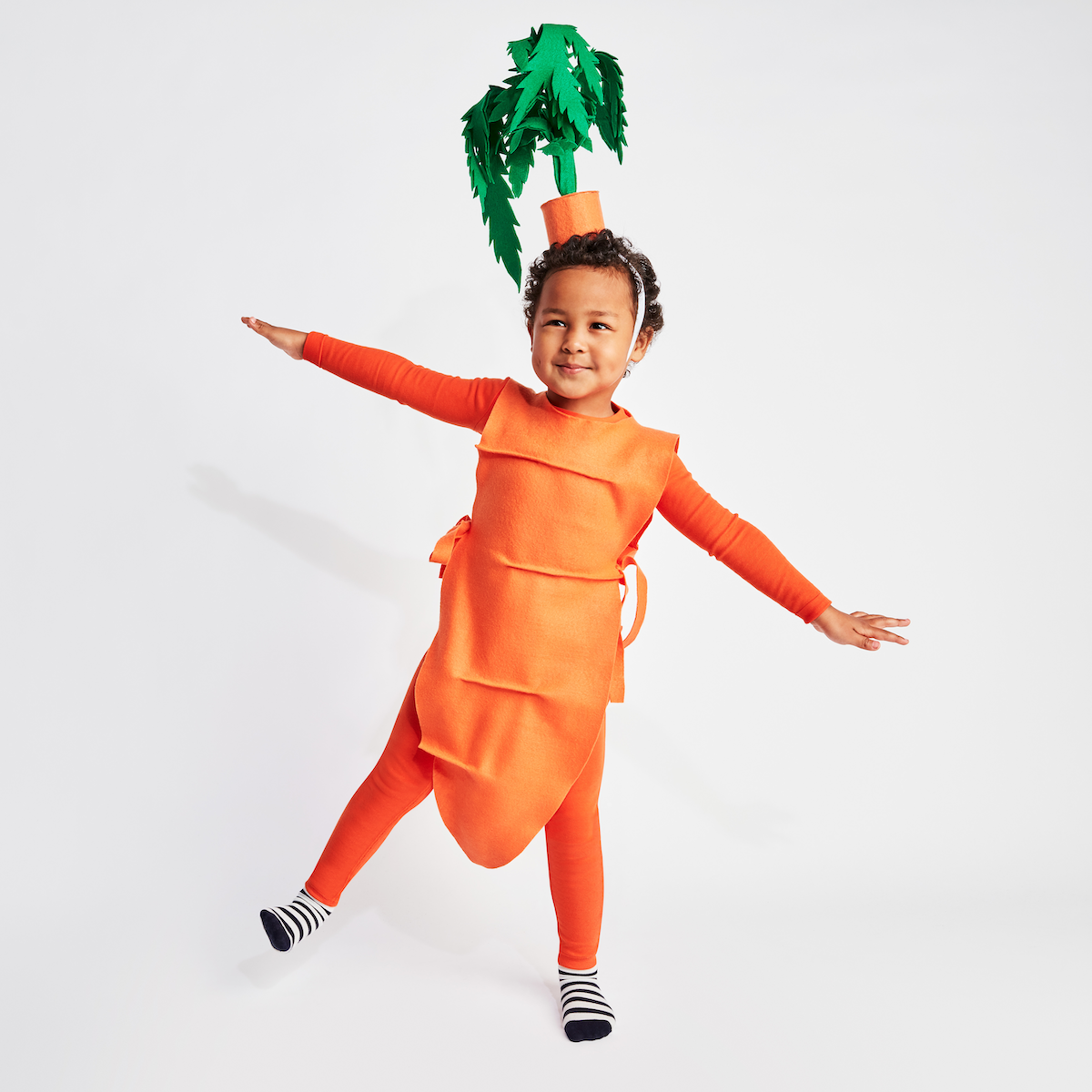 Carrot (Kid): A child wearing an orange outfit dressed as a carrot. 