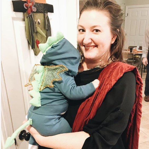 Dragon (Baby): A baby wearing a blue outfit with green dragon scales down the back.