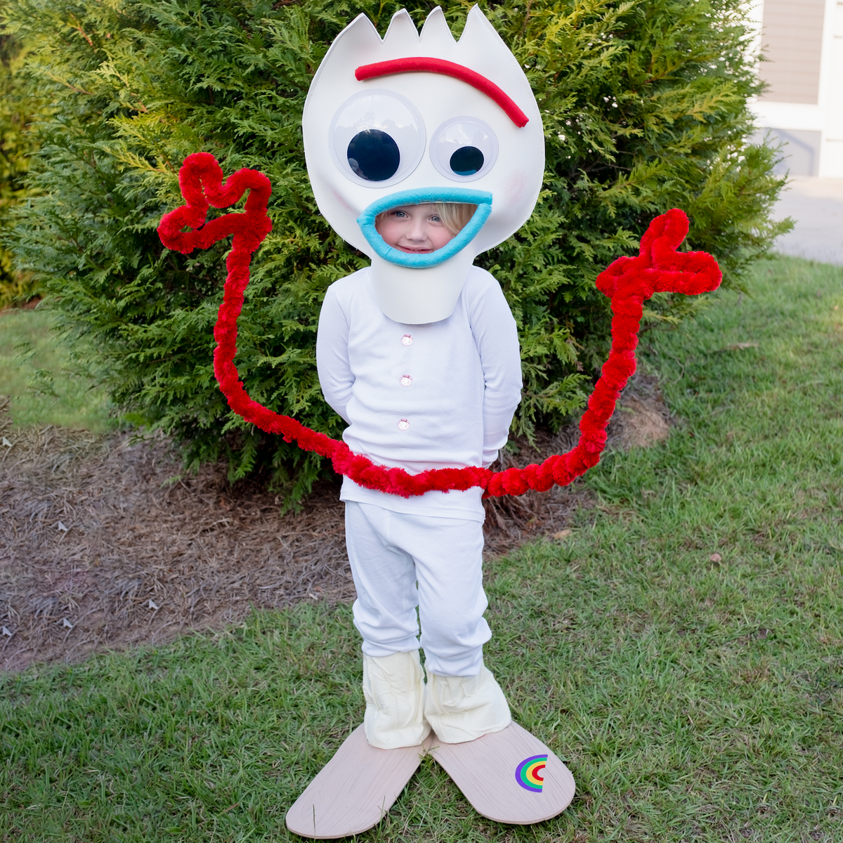 Forky (from Toy Story): A child wearing a white outfit with a forky inspired headpiece and pipe cleaner arms around the waist.