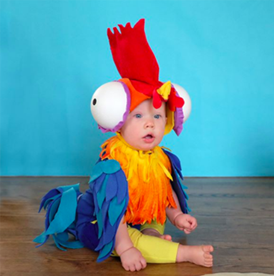 Hei Hei (Baby): A baby in a pink top and yellow bottom with Hei Hei inspired DIY embellishments