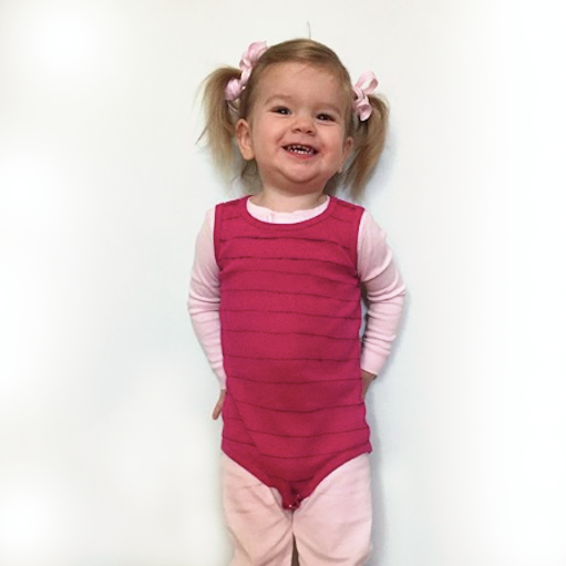 Piglet: A child wearing a pink outfit with a hot striped pink bodysuit overtop