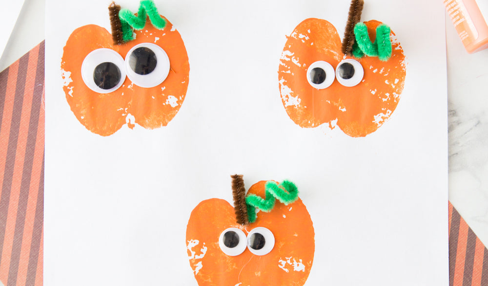 photo of orange pumpkins with googly eyes on them and pipecleaner stems and leaves