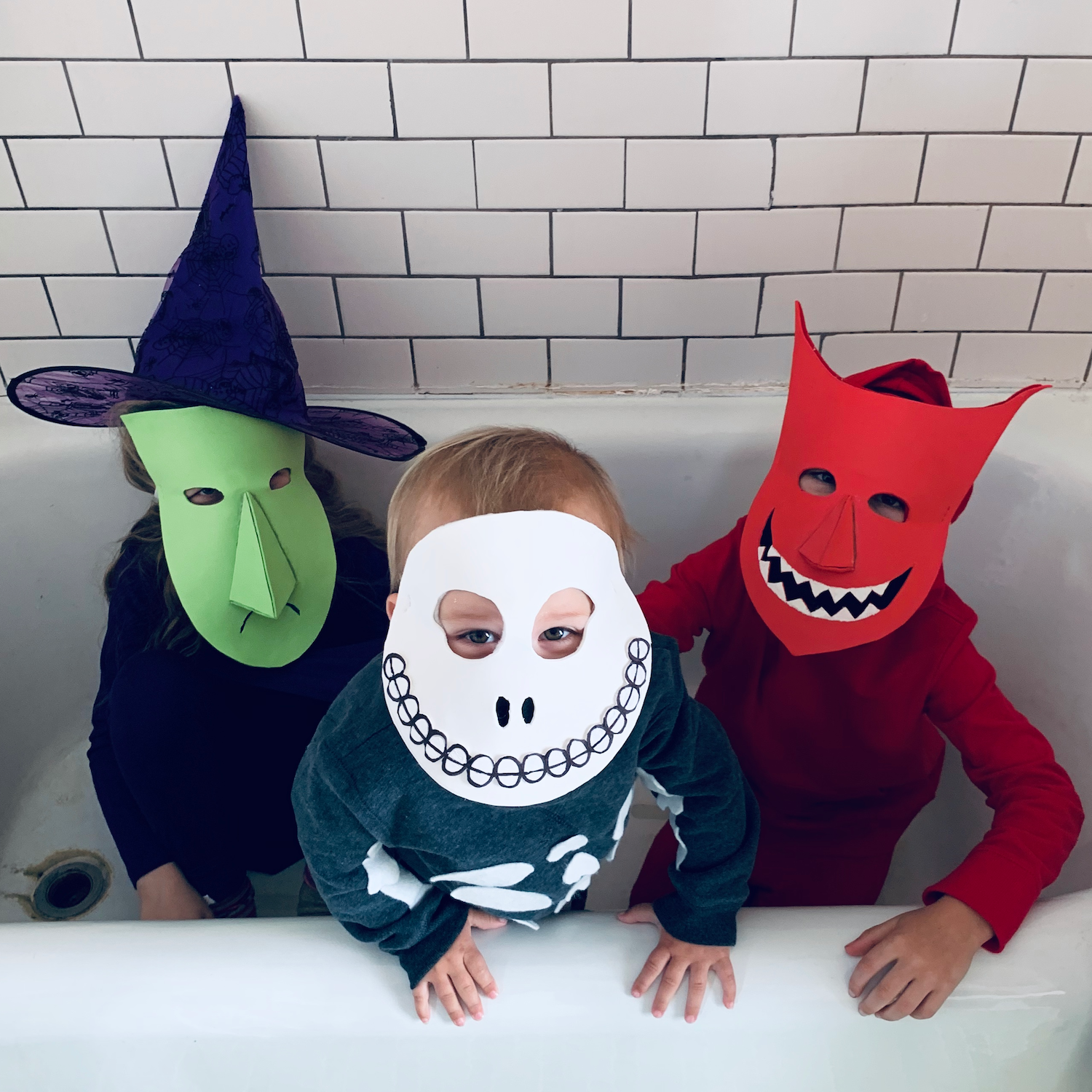 Lock, Shock & Barrel (from the Nightmare Before Christmas): three children, one wearing a purple outfit, another wearing a gray outfit and the third wearing a red outfit; all with masks inspired by the Nightmare Before Christmas.