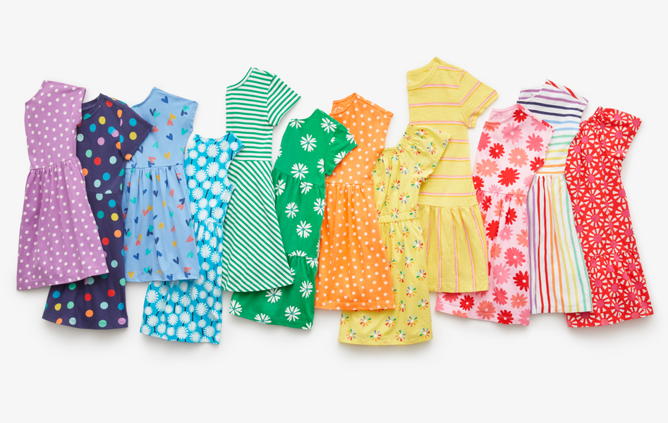 An image showing 12 different dresses in a rainbow order