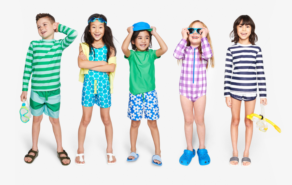 5 children in mix-and-match swim styles in shades of green, blue, and purple.