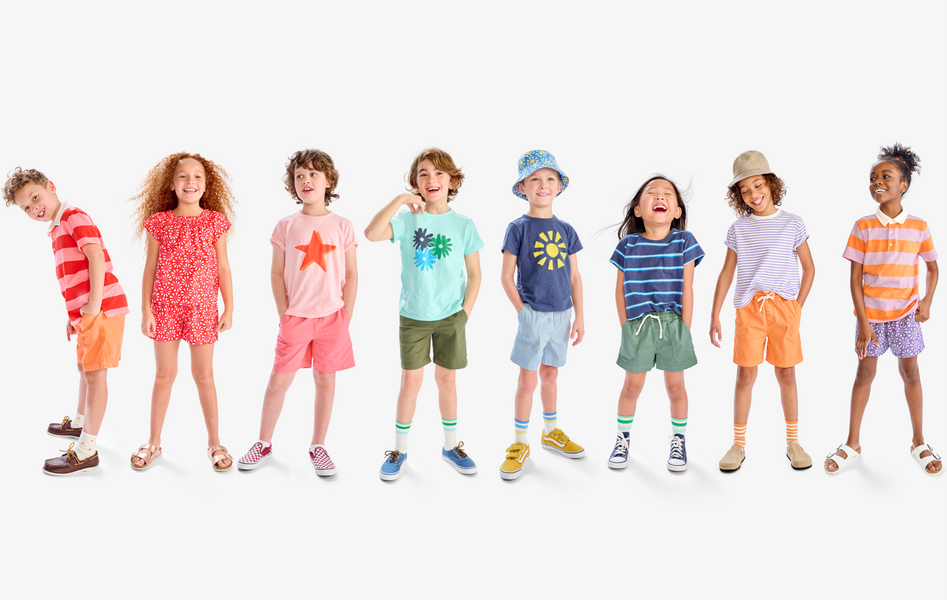 A group of kids wearing a rainbow of outfits including our new tees and shorts.