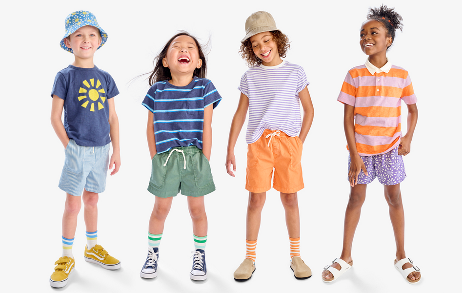 A group of kids wearing a rainbow of outfits including our new tees and shorts.