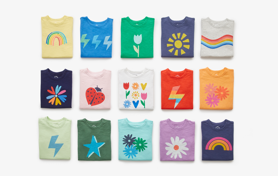 A grid of 15 graphic tees neatly folded in a 5 by 3 layout. 