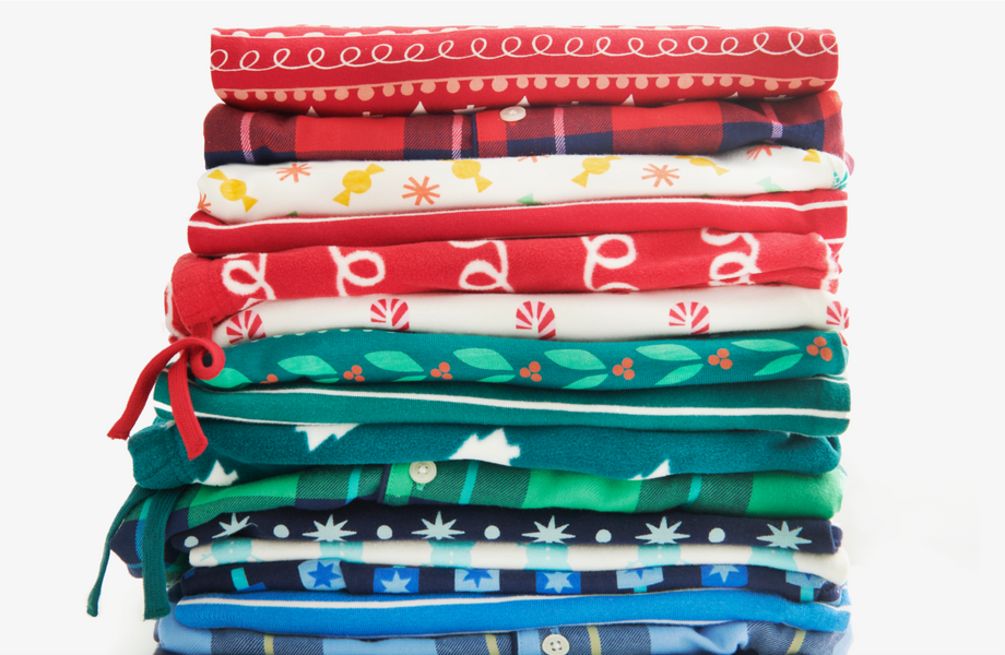 A stack of this seasons kids PJ pants showing all the different holiday prints.