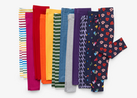 An image of 13 kids legging laying flat showing a rainbow of color and prints