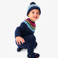 A baby wearing our new navy fair isle rompre with matching navy fair isle hat