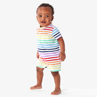 A baby wearing out polo shortie in rainbow stripe