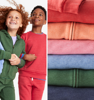 A group of kids wearing our cozy heathered fleece sweats in red, blue, and green.