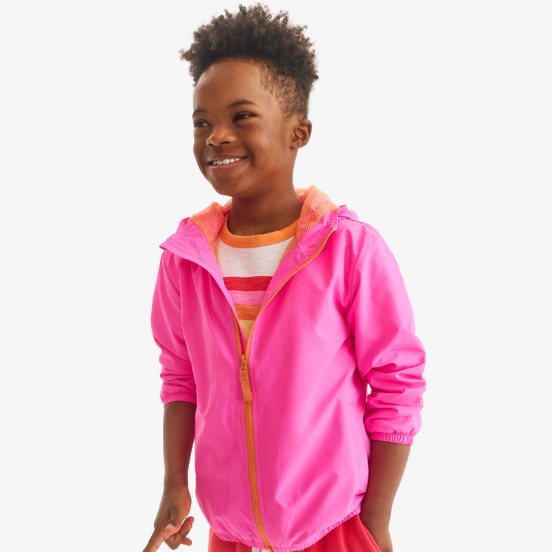 Child wearing a pink jacket with an orange zipper on a white background