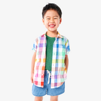 A boy wearing out short sleeve button down in rainbow gingham