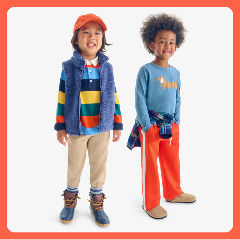 2 kids standing side by side where new fall clothing part if our orange color story